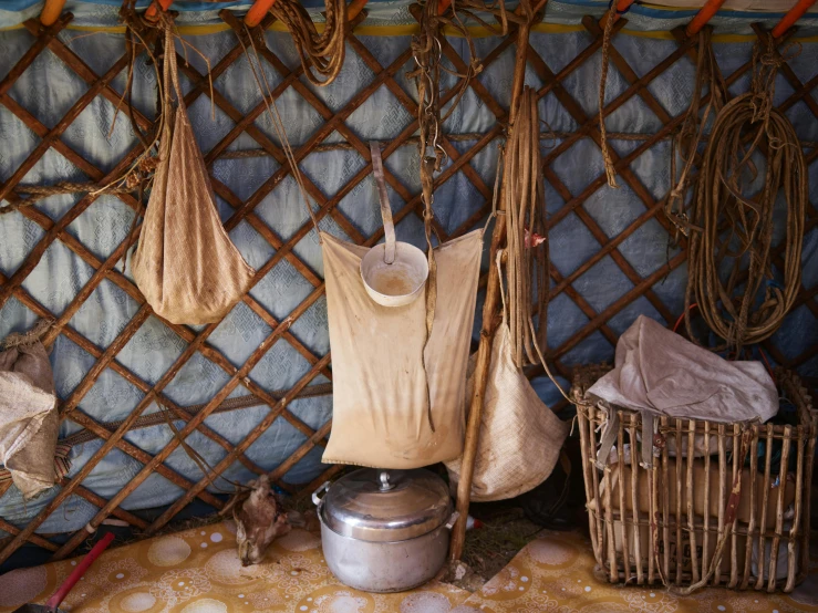 a kitchen filled with pots and pans on top of a table, a portrait, plasticien, tribal yurta, hanging beef carcasses, tent, thumbnail