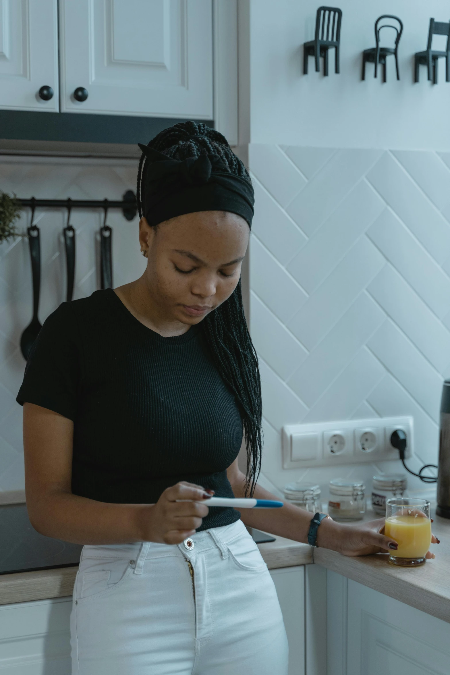 a woman standing in a kitchen looking at her phone, pexels contest winner, a teen black cyborg, low quality footage, trading card, healthcare worker