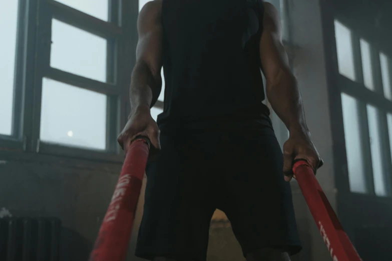 a man standing in front of a window holding a baseball bat, carrying two barbells, mkbhd, middle close up shot, ropes