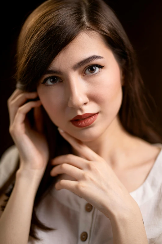 a woman holding a cell phone to her ear, a portrait, inspired by Yousuf Karsh, trending on pexels, gemma chan girl portrait, high angle closeup portrait, brown, anna nikonova aka newmilky