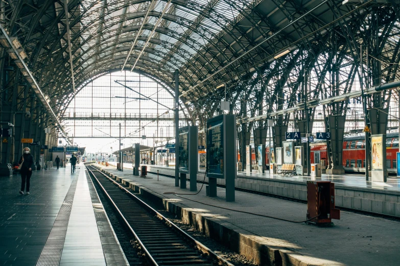 a train station with a train on the tracks, pexels contest winner, art nouveau, steel archways, 💋 💄 👠 👗, nordic, thumbnail