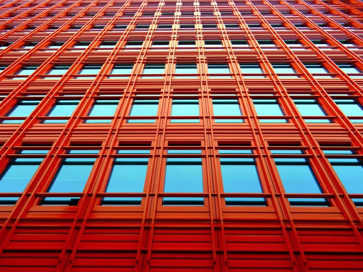 a tall red building with lots of windows, inspired by Christo, flickr, op art, blue and orange tones, steel window mullions, foster and partners, archdaily