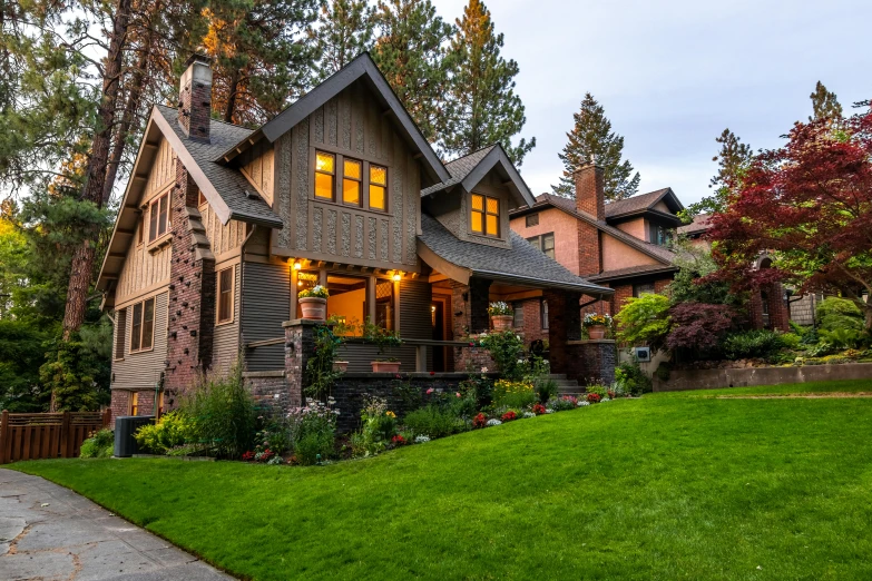 a large house sitting on top of a lush green field, pexels contest winner, arts and crafts movement, reddish exterior lighting, black fir, neighborhood, a quaint