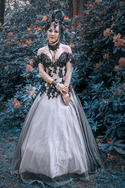 a woman in a black and white dress posing for a picture, inspired by reyna rochin, renaissance, corpse bride style, transparent gray dress, lady with glowing flowers dress, closeup!!!!!!