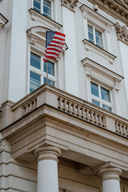 an american flag hanging from the side of a building, unsplash, berlin secession, low quality photo, in legnica city hall, profile image, balcony
