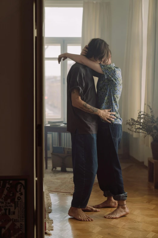 a couple standing next to each other in a living room, a tattoo, inspired by Elsa Bleda, hyperrealism, hugs, movie filmstill, stillframe, leaving a room