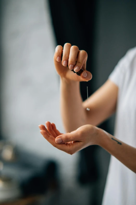 a close up of a person holding something in their hand, beads of sweat, serving body, arms stretched out, slightly minimal