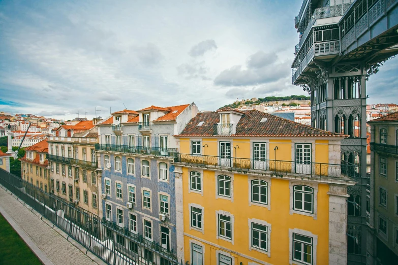 a couple of buildings that are next to each other, inspired by Almada Negreiros, pexels contest winner, art nouveau, colorful”, grey, square, panoramic view