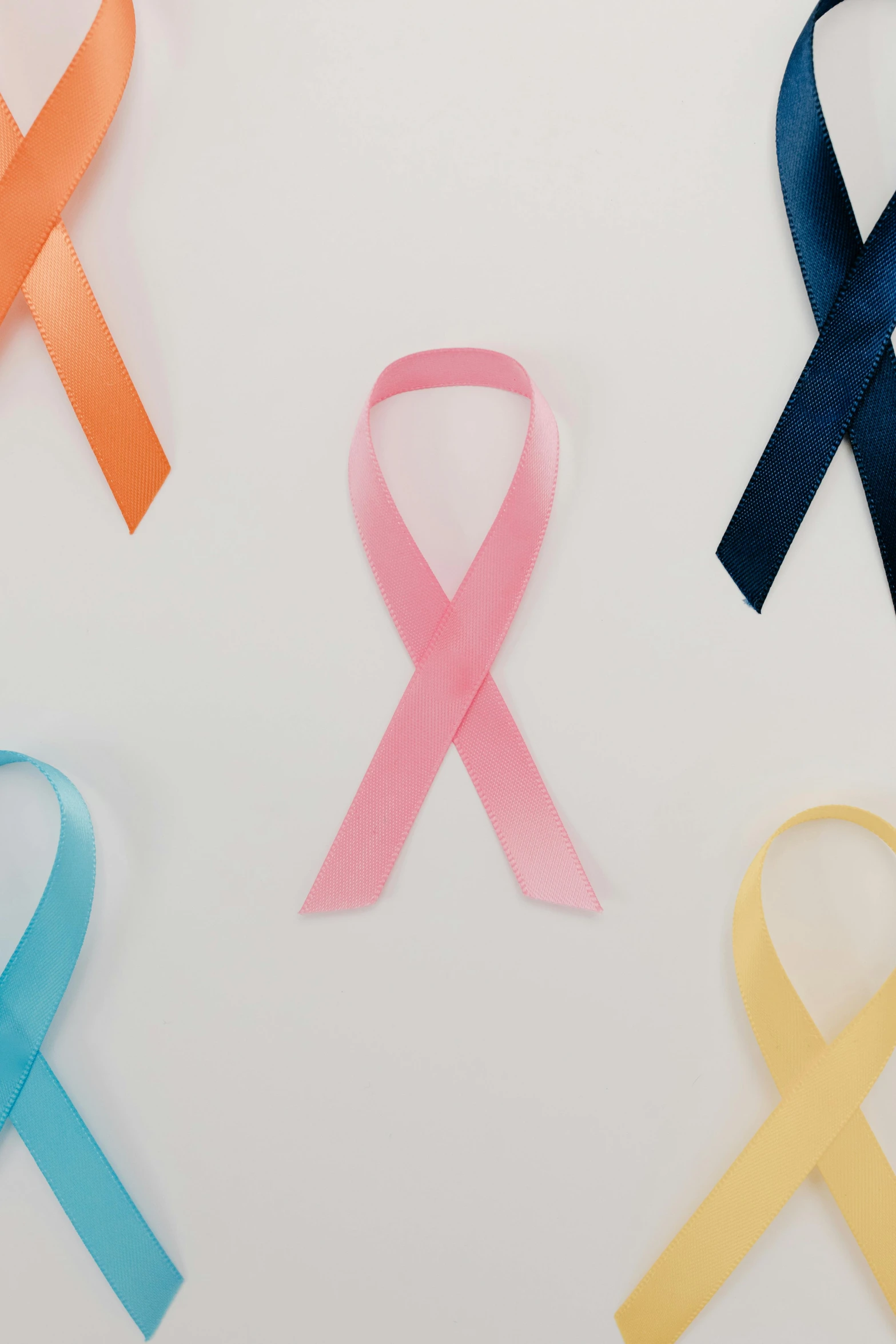 a number of different colored ribbons on a white surface, a cartoon, by Carey Morris, pexels, the cure for cancer, profile photo, award - winning shot, detail shot