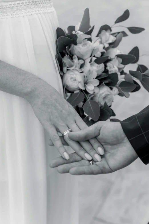 a black and white photo of a bride and groom holding hands, by Elizabeth Durack, renaissance, - photorealistic, rings, bouquets, still photograph