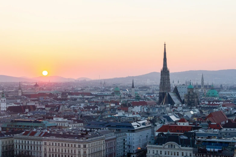 an aerial view of a city at sunset, pexels contest winner, viennese actionism, mountains in background, olafur eliasson, spire, fine art print