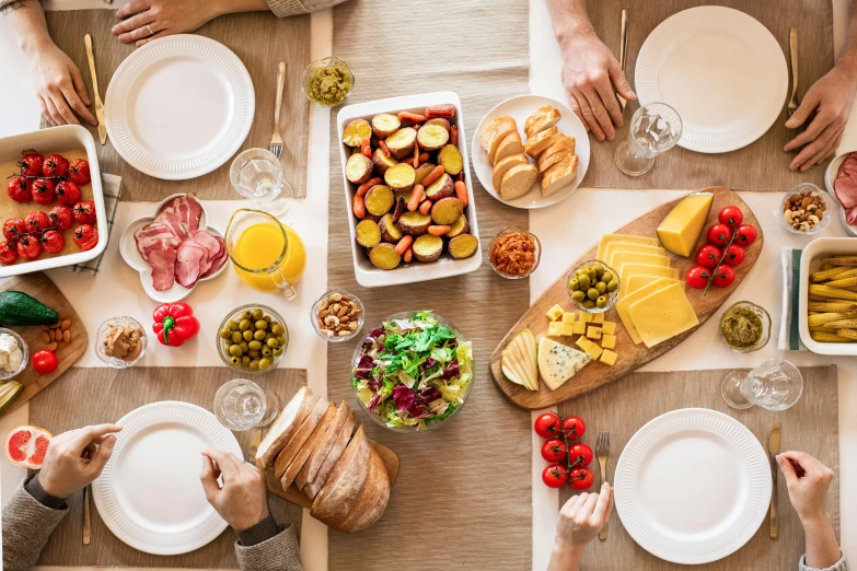 a group of people sitting at a table with plates of food, pexels contest winner, figuration libre, table set for second breakfast, cheese and salami on the table, 🦩🪐🐞👩🏻🦳, family friendly