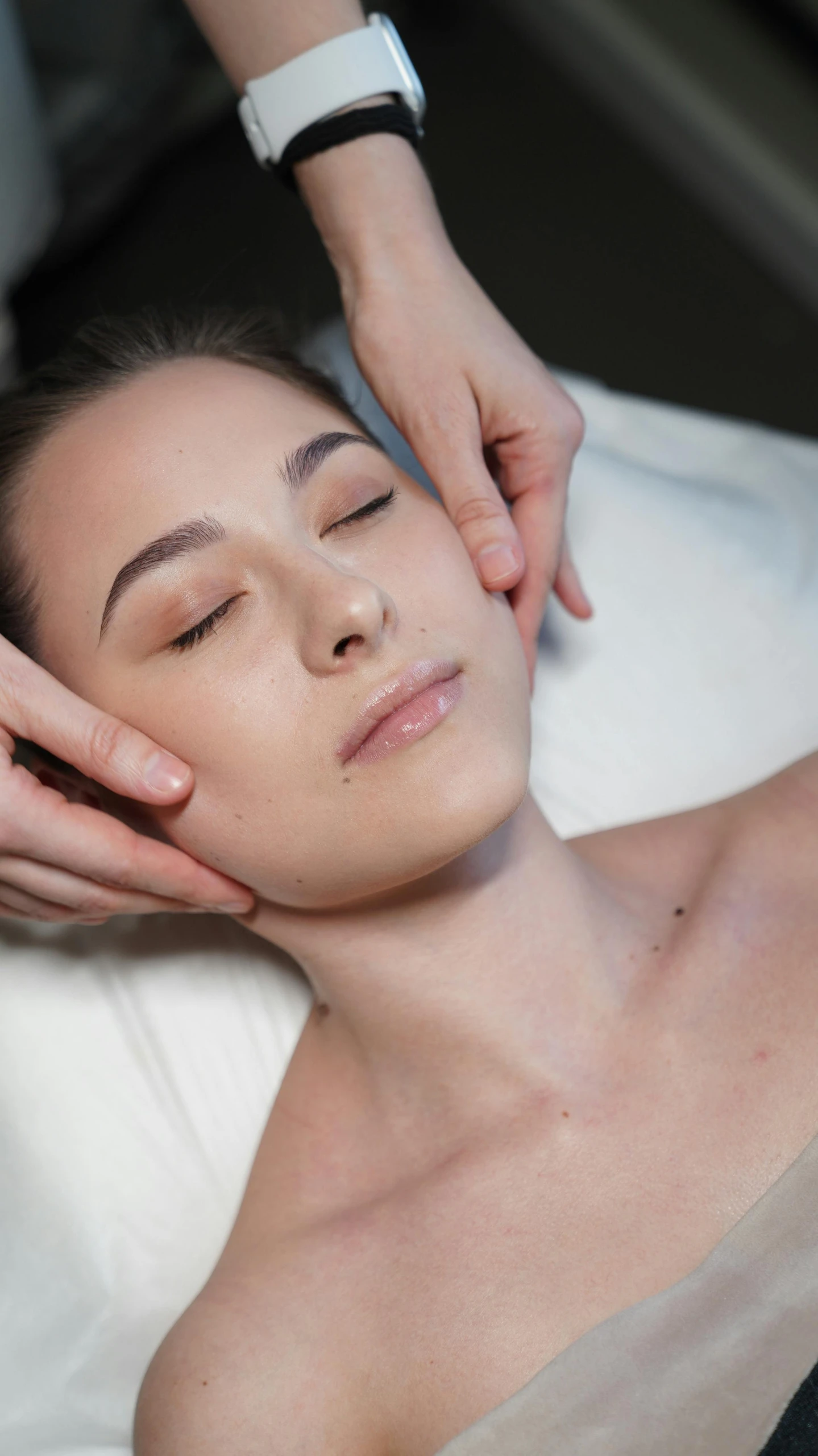 a woman getting a facial massage at a spa, by Robbie Trevino, shutterstock, massurrealism, square facial structure, sleepy fashion model face, soft flawless pale skin, instagram photo
