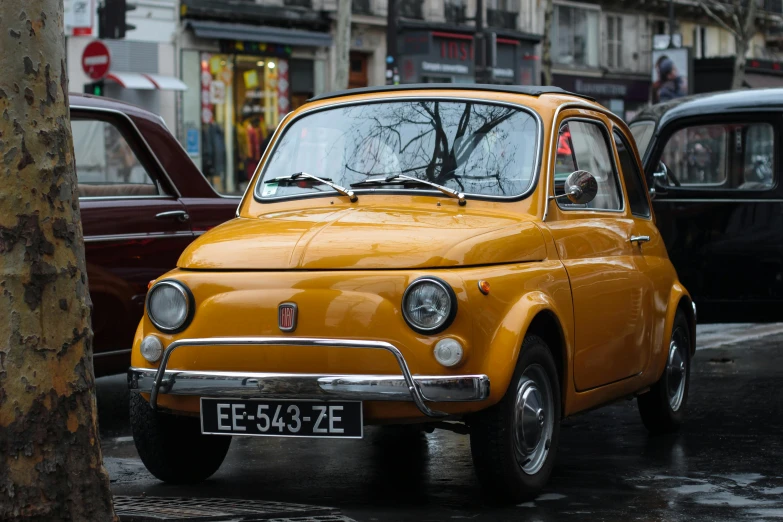 a small yellow car parked on the side of the road, a portrait, pexels contest winner, renaissance, in paris, brown, medium format, a colorful