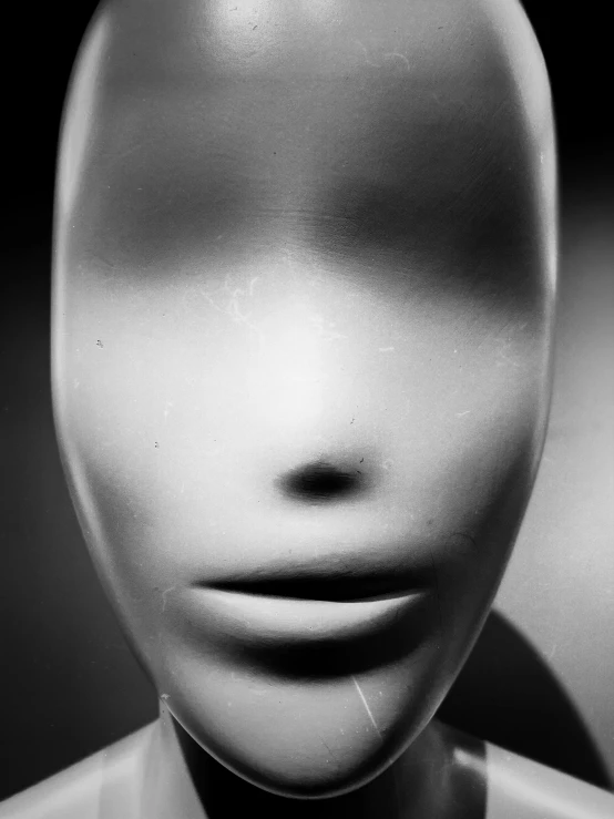 a black and white photo of a mannequin head, inspired by Robert Mapplethorpe, surrealism, by greg rutkowski, {perfect face}, portrait of an alien, faceless