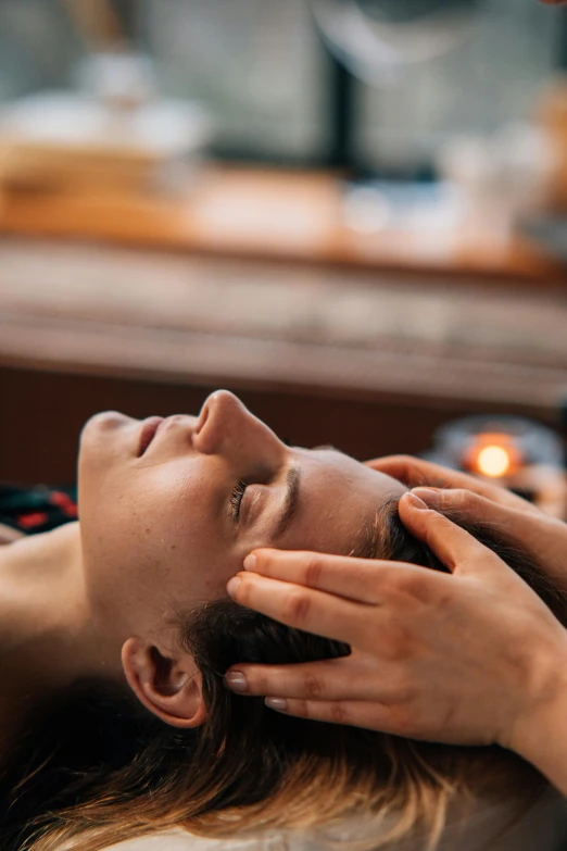 a woman getting a facial massage in a salon, a portrait, by Julia Pishtar, trending on pexels, renaissance, head straight down, thumbnail, iceland, beautifully soft lit