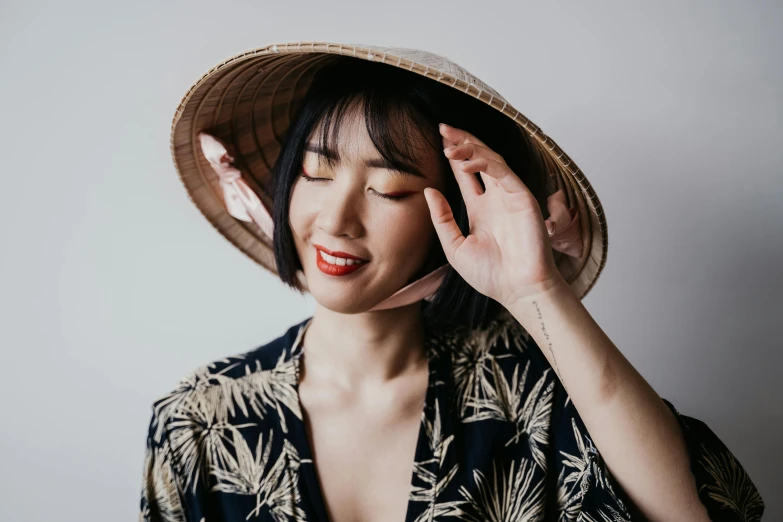 a woman in a hat talking on a cell phone, inspired by Itō Shinsui, trending on pexels, vietnamese woman, tall forehead, various posed, ethnicity : japanese