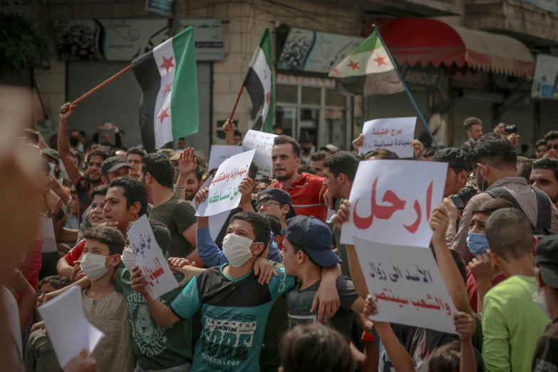 a crowd of people holding signs and flags, a picture, hurufiyya, damascus, thumbnail, square, contain