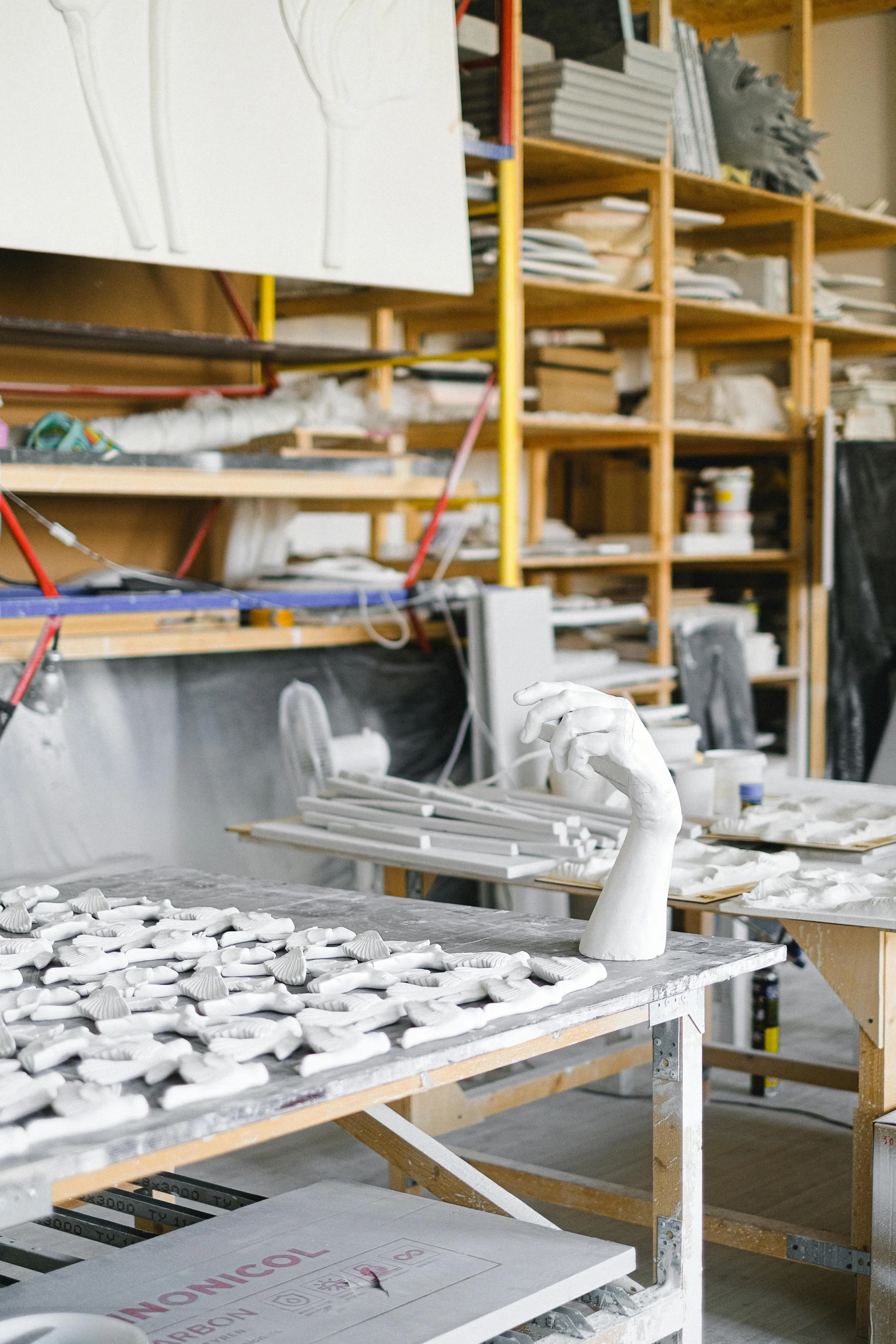 a room filled with lots of shelves filled with assorted items, a marble sculpture, arbeitsrat für kunst, production ready, hands on counter, white clay, plating