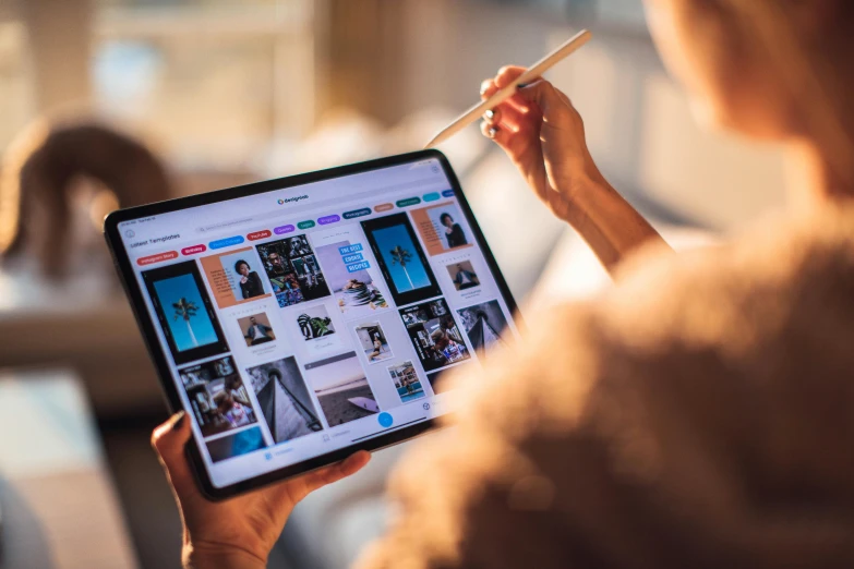 a woman holding a tablet computer in her hands, a picture, trending on pexels, 🦩🪐🐞👩🏻🦳, google arts and cultures, top of pinterest, professional shot