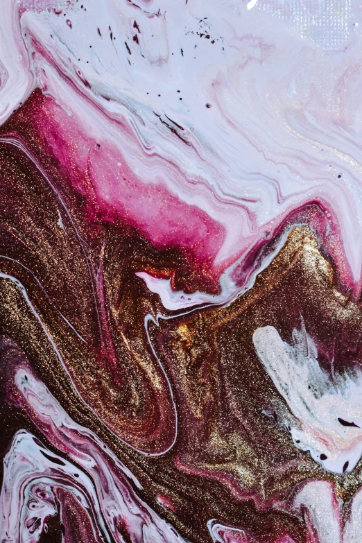 a close up of a piece of art on a table, inspired by Julian Schnabel, trending on pexels, abstract art, chocolate river, pink scheme, metallic nebula, maroon