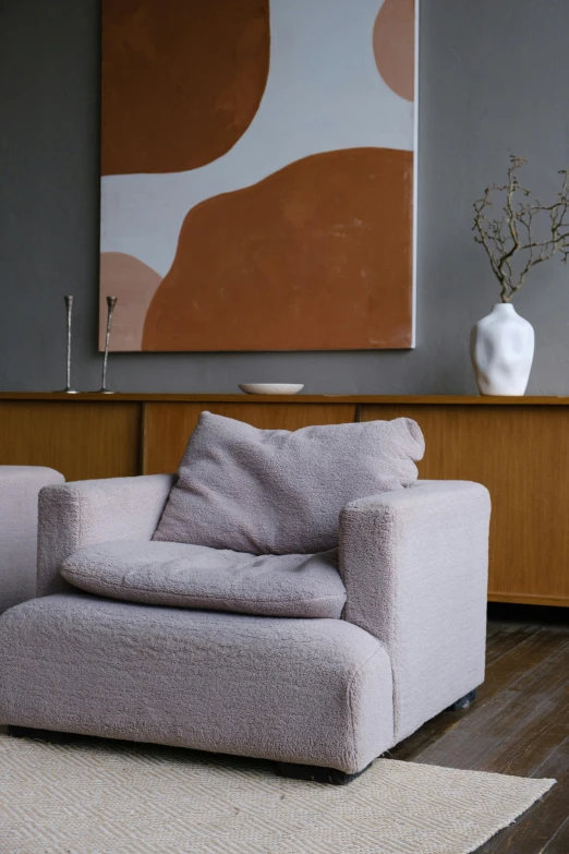 a living room filled with furniture and a painting, inspired by Isamu Noguchi, unsplash, visual art, lavender blush, sheep wool, close up portrait shot, armchair