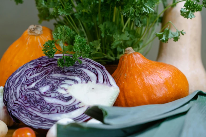 a bunch of vegetables sitting on top of a table, deep purple and orange, portrait image, full width, autumn colours