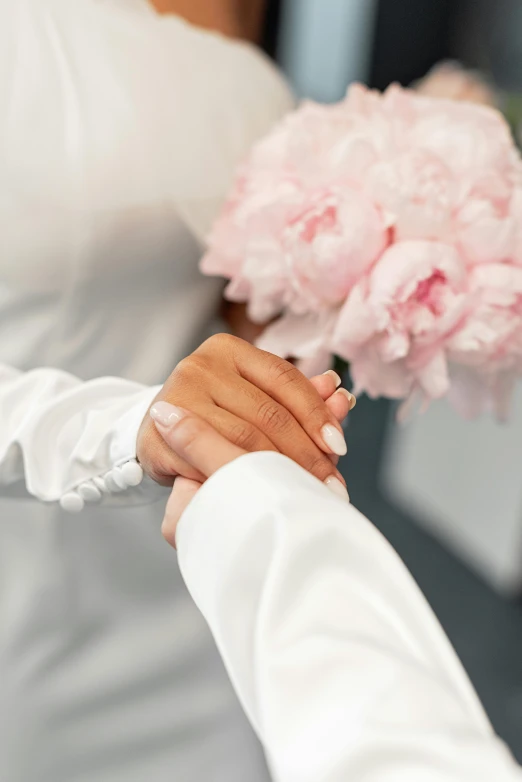 a man handing a bouquet of pink flowers to a woman, inspired by Ruth Jên, wearing white silk robe, holding hands, zoomed out, white sleeves