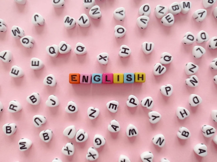 the word english spelled in wooden letters on a pink background, shutterstock, art & language, y 2 k aesthetic, school class, miniatures, taken on iphone 14 pro