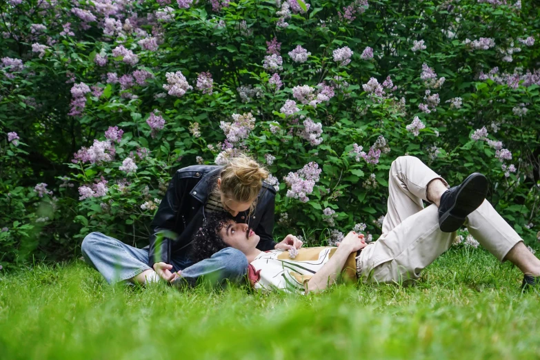 a couple of people that are laying in the grass, a picture, by Nina Hamnett, timothee chalamet, springtime, lgbtq, high res photo