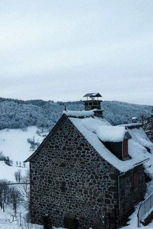 a stone building sitting on top of a snow covered hillside, inspired by Pierre Toutain-Dorbec, les nabis, black forest, rooftop, a high angle shot, today\'s featured photograph 4k