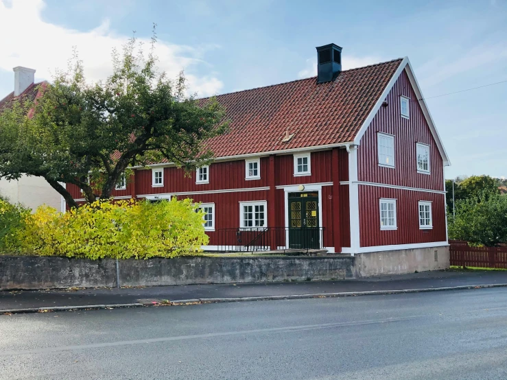 a red house sitting on the side of a road, a picture, by Svend Rasmussen Svendsen, restaurant, profile image, old building, exterior view