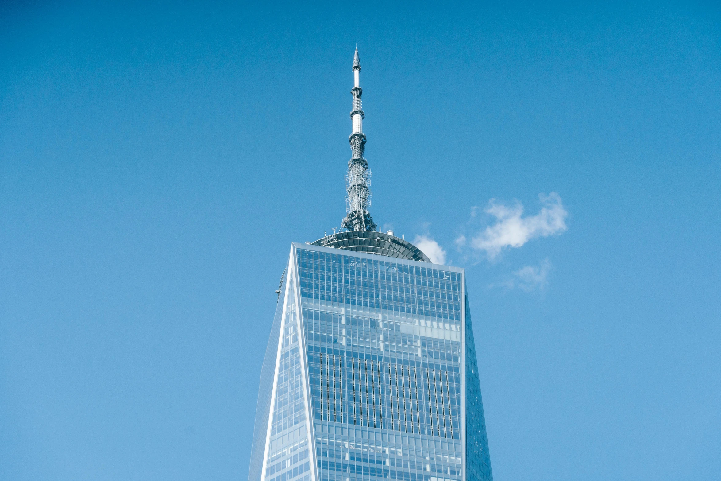 the top of one world trade center in new york city, pexels contest winner, modernism, cloudless sky, side view from afar, shiny silver, 1 4 9 3