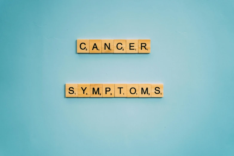 scrabbles spelling cancer and symptoms on a blue background, by Caroline Mytinger, pexels, black mold, instagram picture, - 12p, symphony