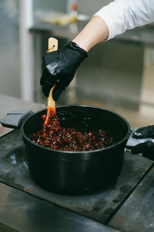 a person in a kitchen preparing food on a stove, dripping bbq sauce, jelly - like texture, 4l, black resin