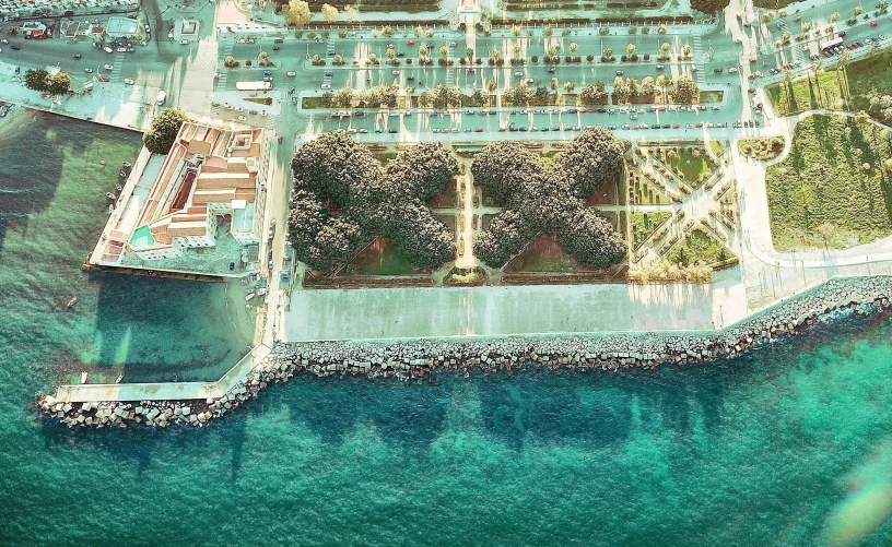 an aerial view of the eiffel tower in paris, a colorized photo, by Giorgio Cavallon, next to the sea, mies van der rohe, mediterranean, botanical garden