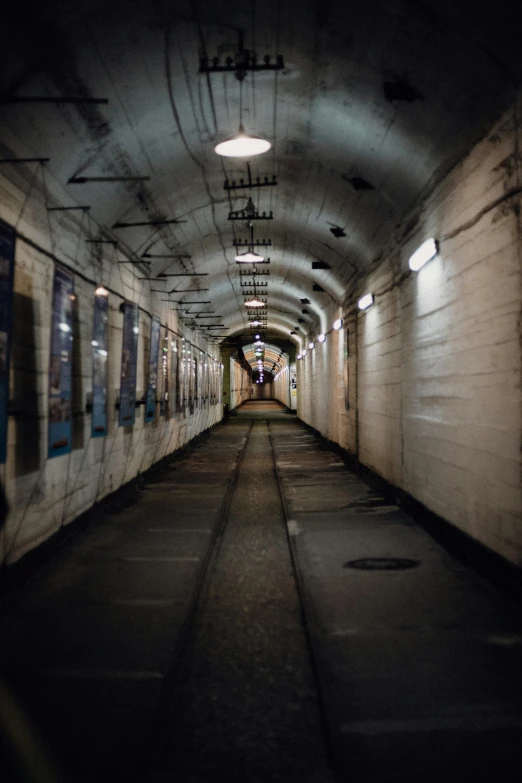 a subway train traveling through a subway tunnel, by Jens Søndergaard, unsplash contest winner, military buildings, prison cell, navy, preserved historical