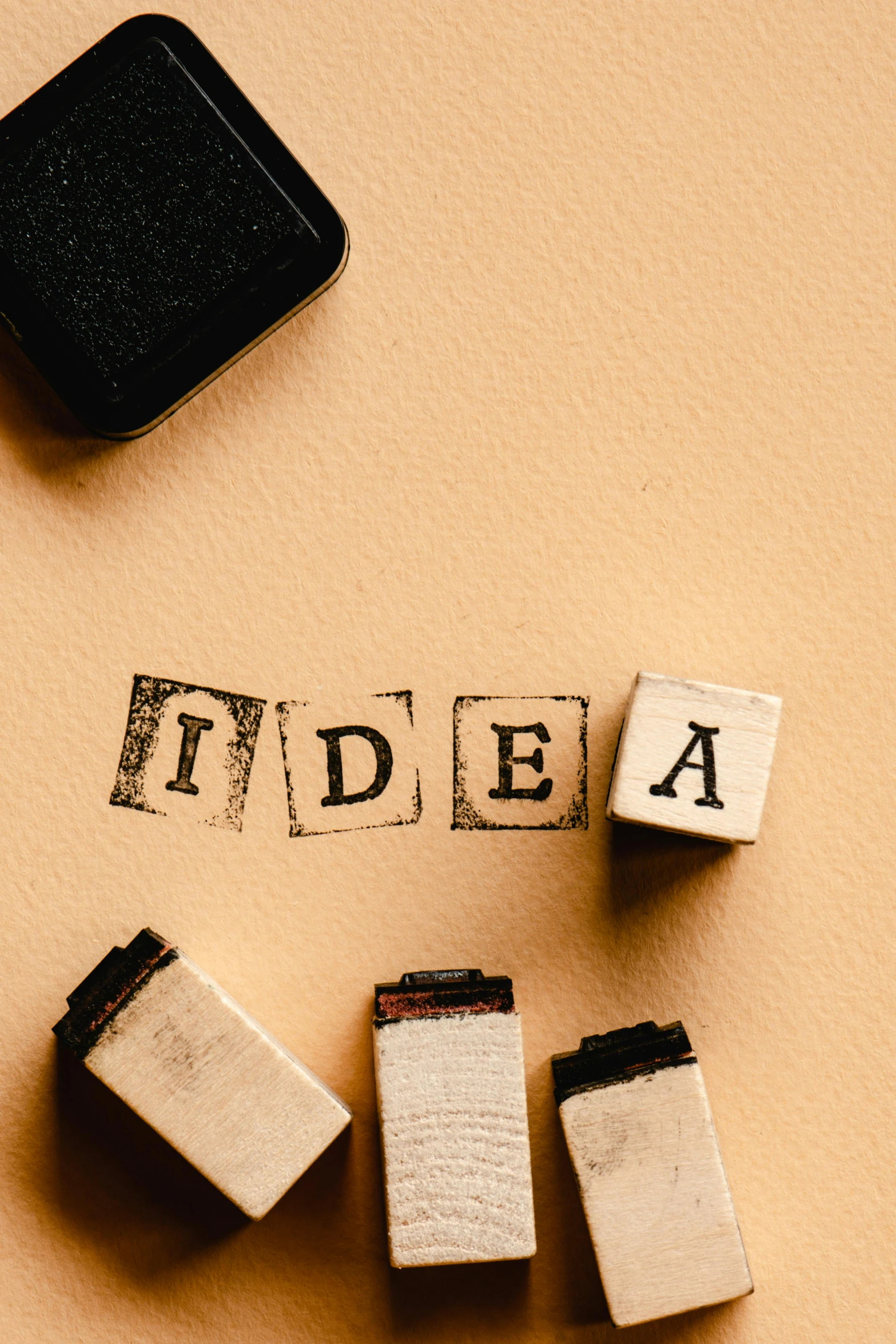 a wooden block with the word idea written on it, poster art, trending on pexels, conceptual art, stamp, thumbnail, schools, 15081959 21121991 01012000 4k