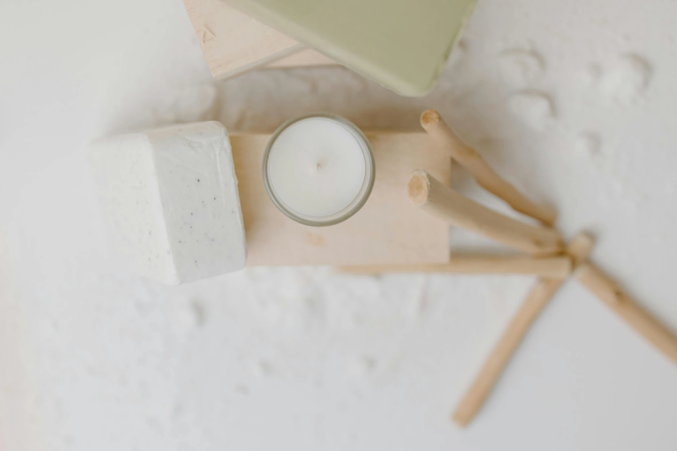 a couple of candles sitting on top of a table, white paint, holding a wood piece, detailed product image, bath