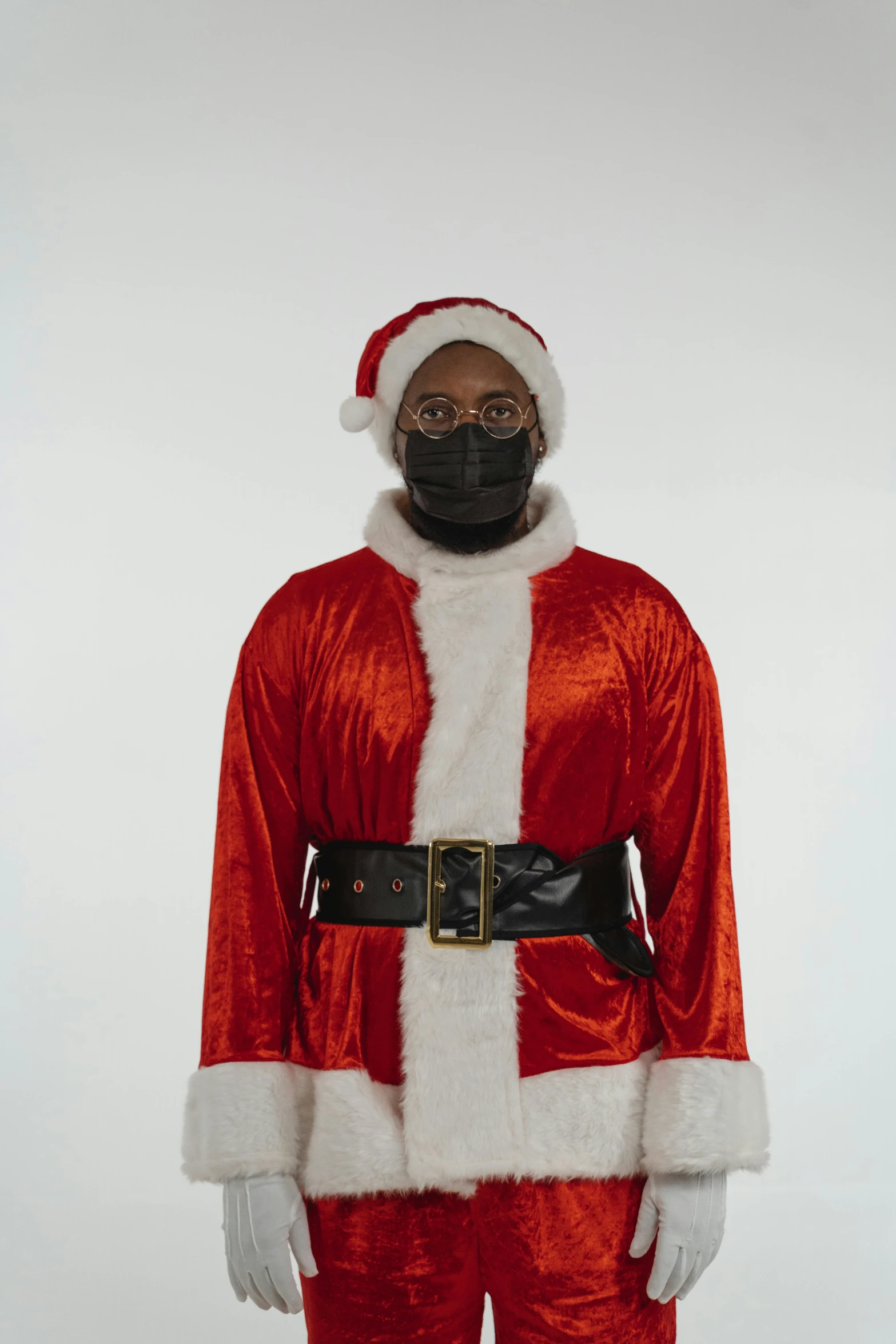 a man wearing a santa suit and mask, an album cover, by Carey Morris, riyahd cassiem, without text, ( ( brown skin ) ), he is wearing a black