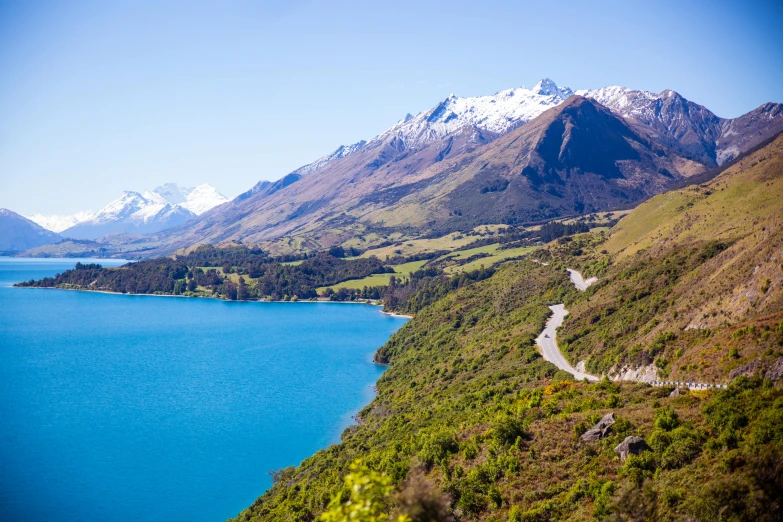 a scenic view of a lake with mountains in the background, by Sophie Pemberton, pexels contest winner, hurufiyya, new zeeland, blue waters, road trip, overlooking a valley with trees