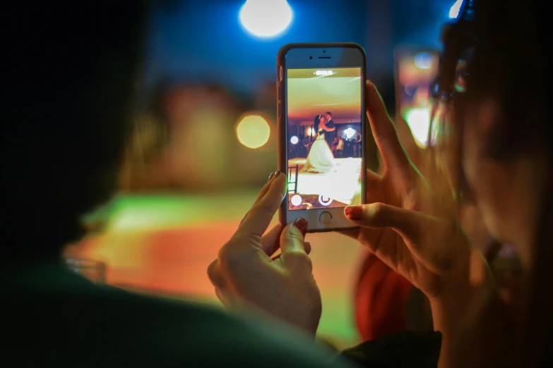 a person taking a picture of a baseball game on a cell phone, by Julia Pishtar, trending on pexels, happening, hero pose colorful city lighting, square, avatar image, award-winning