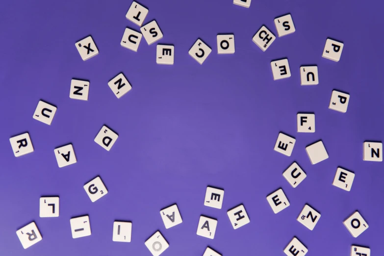 a circle of scrabbles on a purple background, pexels, letterism, background image, alphabet soup, filling the frame, amanda lilleston