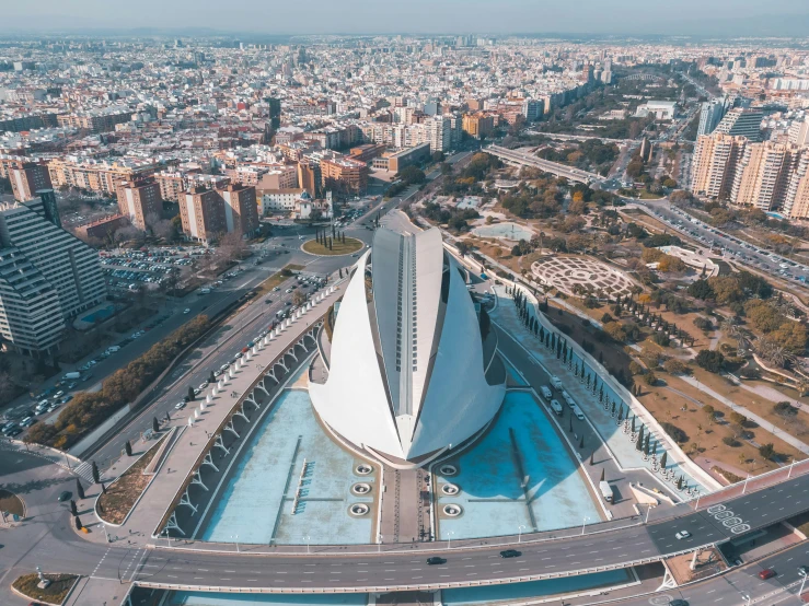 a large building in the middle of a city, by Luis Molinari, pexels contest winner, santiago calatrava, photographic isometric cathedral, wide views, neoprene