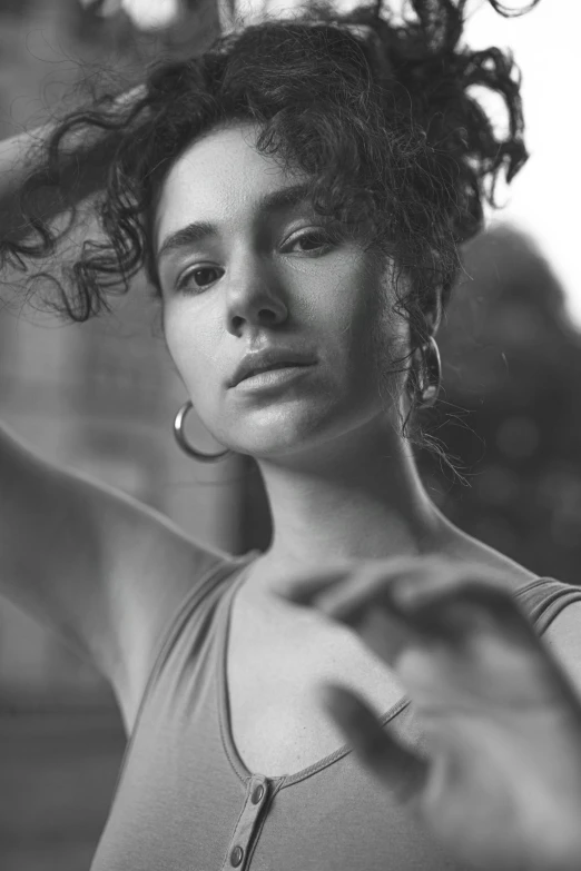 a black and white photo of a woman with curly hair, by Niyazi Selimoglu, oona chaplin, serge marshennikov, she looks like a mix of grimes, golden hour