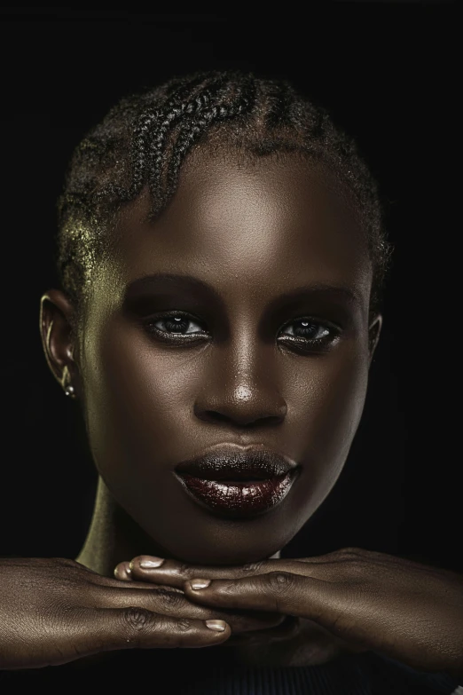 a woman posing with her hands on her face, pexels contest winner, afrofuturism, clean shaven, with black glossy lips, ( ( dark skin ) ), muted brown