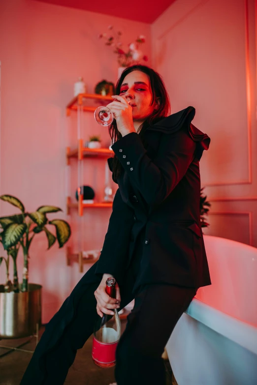 a woman sitting on the edge of a bath tub, an album cover, inspired by Elsa Bleda, pexels contest winner, glam rockers drinking wine, wearing causal black suits, goth aesthetic, profile image