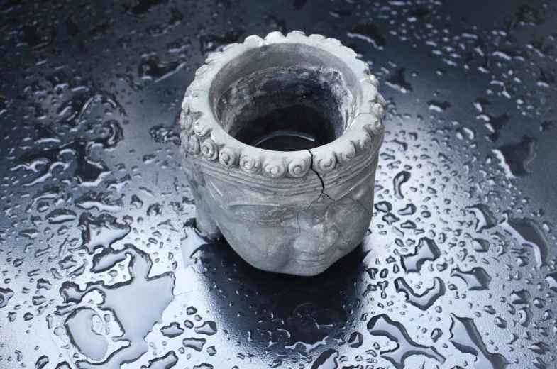 a white vase sitting on top of a table covered in water, a marble sculpture, inspired by Hendrik Gerritsz Pot, unsplash, concrete art, oriental face, ornamental halo, just after rain, holding a candle holder