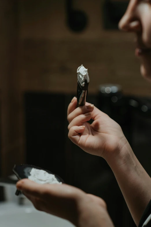 a woman holding a piece of cake in her hand, a charcoal drawing, trending on pexels, marijuana smoke, a folding knife, white metal, professional image