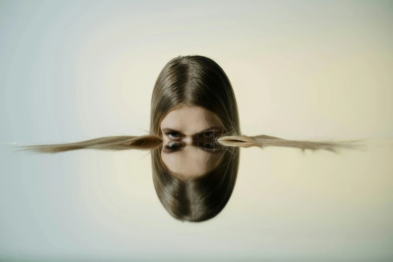 a woman with long hair is reflected in the water, an album cover, inspired by Anna Füssli, unsplash, surrealism, ignant, minimalist photorealist, still from the movie ex machina, upside-down